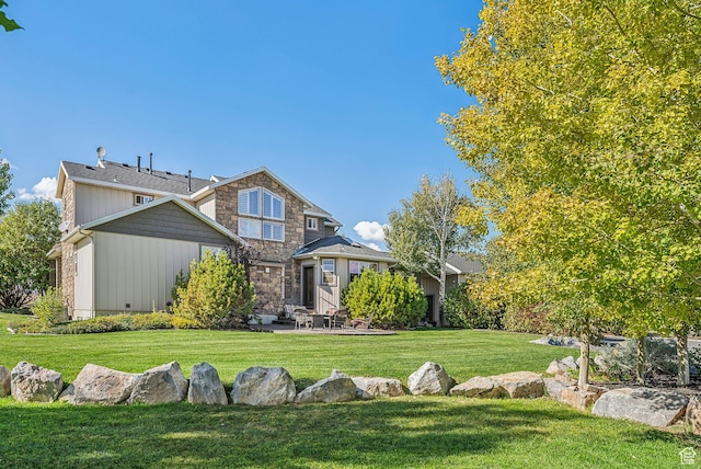 8938 N Canyon Wash Dr, Eagle Mountain, UT 84005 - craftsman inspired home with crawl space, stone siding, a patio area, and a front lawn