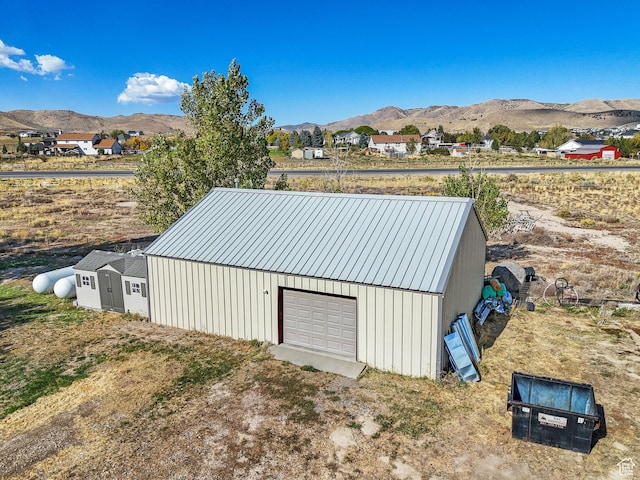 8938 N Canyon Wash Dr, Eagle Mountain, UT 84005 - view of outbuilding featuring an outbuilding, dirt driveway, a mountain view, and a garage