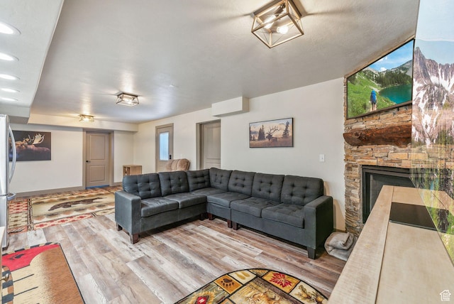 8938 N Canyon Wash Dr, Eagle Mountain, UT 84005 - living area featuring recessed lighting, wood finished floors, and a stone fireplace