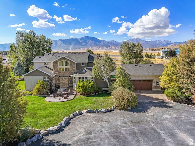 8938 N Canyon Wash Dr, Eagle Mountain, UT 84005 - view of front of house featuring driveway, stone siding, and a mountain view