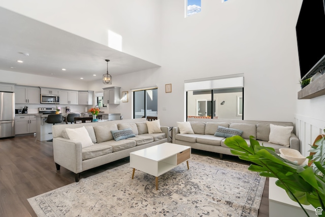 7152 N Brook Rdg, Eagle Mountain, UT 84005 - living room featuring a towering ceiling and wood-type flooring