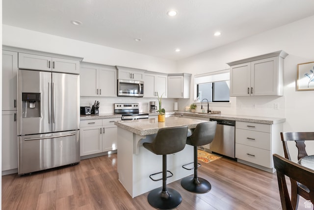 7152 N Brook Rdg, Eagle Mountain, UT 84005 - kitchen featuring a breakfast bar, a center island, stainless steel appliances, and dark hardwood / wood-style floors