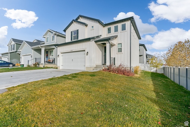 view of front of property with a front yard and a garage