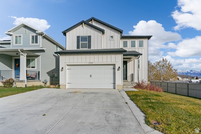 7152 N Brook Rdg, Eagle Mountain, UT 84005 - view of front of property featuring a front lawn, a mountain view, and a garage