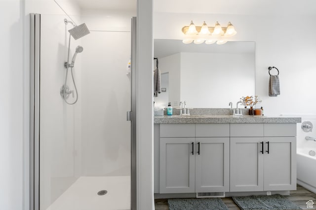 7152 N Brook Rdg, Eagle Mountain, UT 84005 - bathroom featuring hardwood / wood-style floors, vanity, and shower with separate bathtub
