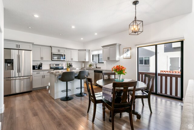 7152 N Brook Rdg, Eagle Mountain, UT 84005 - dining area with sink, dark wood-type flooring, and a notable chandelier