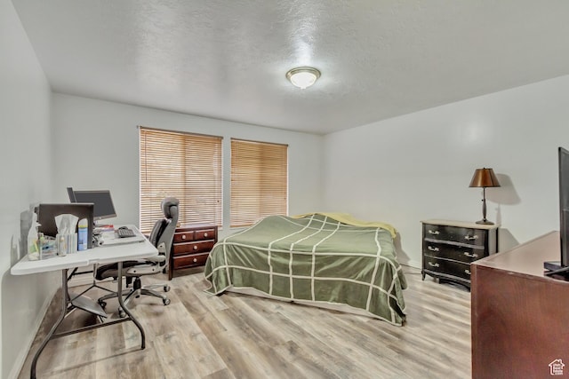 10551 Violet Dr, Sandy, UT 84094 - bedroom featuring light wood-type flooring, a desk, and a textured ceiling