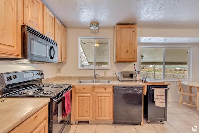 10551 Violet Dr, Sandy, UT 84094 - kitchen with black appliances, light brown cabinetry, light tile patterned floors, light countertops, and a textured ceiling