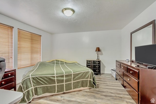 10551 Violet Dr, Sandy, UT 84094 - bedroom featuring light wood finished floors and a textured ceiling