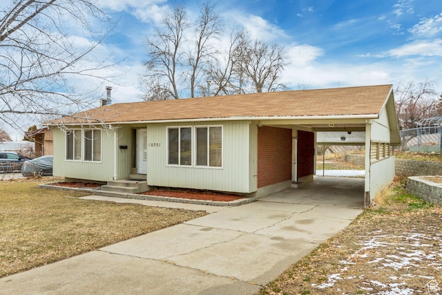 10551 Violet Dr, Sandy, UT 84094 - view of front facade featuring concrete driveway, an attached carport, and a shingled roof