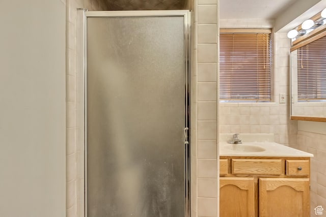10551 Violet Dr, Sandy, UT 84094 - full bath featuring a stall shower, tile walls, and vanity