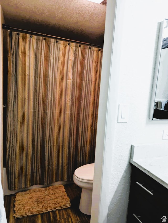 102 S Alpine Ln # A-4, Brian Head, UT 84719 - bathroom featuring vanity, curtained shower, a textured ceiling, hardwood / wood-style flooring, and toilet