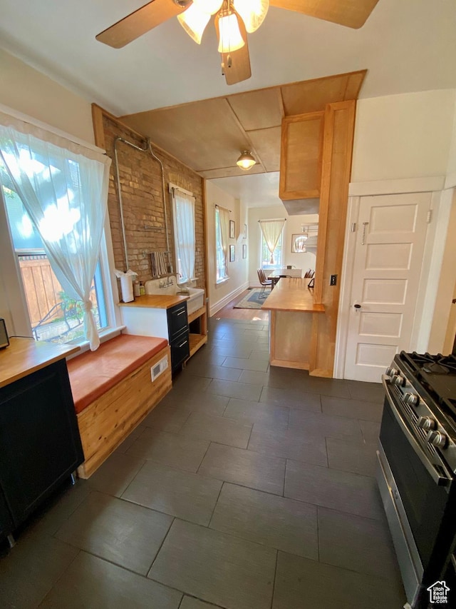 931 E Laird Ave S, Salt Lake City, UT 84105 - kitchen with stainless steel gas range, light countertops, visible vents, and ceiling fan