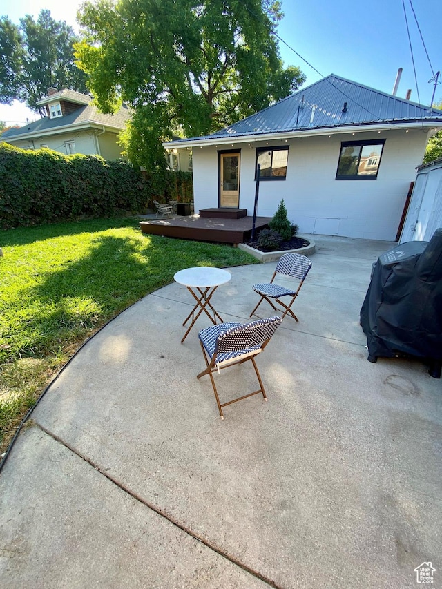 931 E Laird Ave S, Salt Lake City, UT 84105 - back of property with a patio, a yard, and metal roof