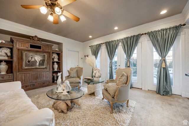 living room featuring a ceiling fan, light colored carpet, ornamental molding, and recessed lighting