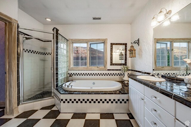 full bath featuring visible vents, a garden tub, a stall shower, and a healthy amount of sunlight