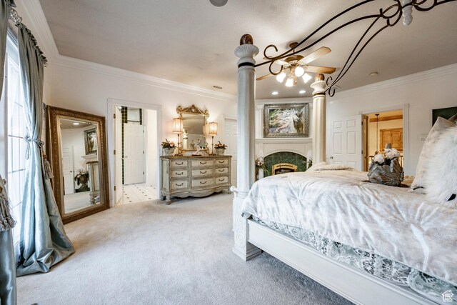 carpeted bedroom with ornamental molding and ornate columns