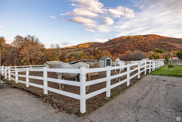 view of yard with a mountain view, a fenced front yard, and a rural view