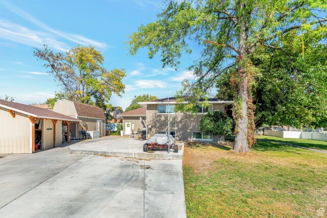 view of front of home with a front yard and fence