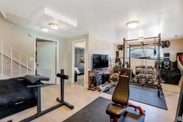 workout room with visible vents and wood finished floors