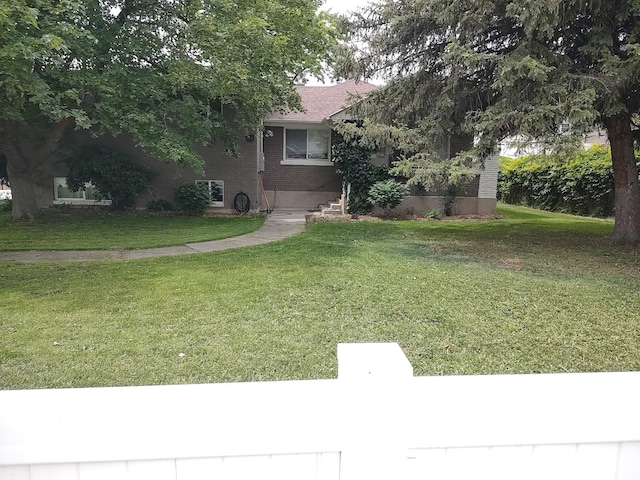 6724 S 2200 W, West Jordan, UT 84084 - obstructed view of property featuring a front yard and brick siding