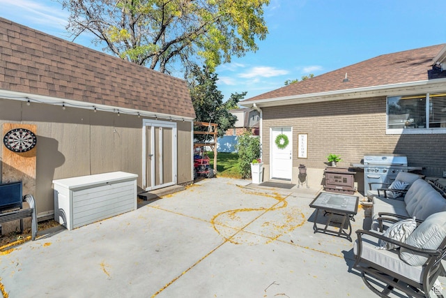 view of patio featuring an outdoor living space with a fire pit and a grill