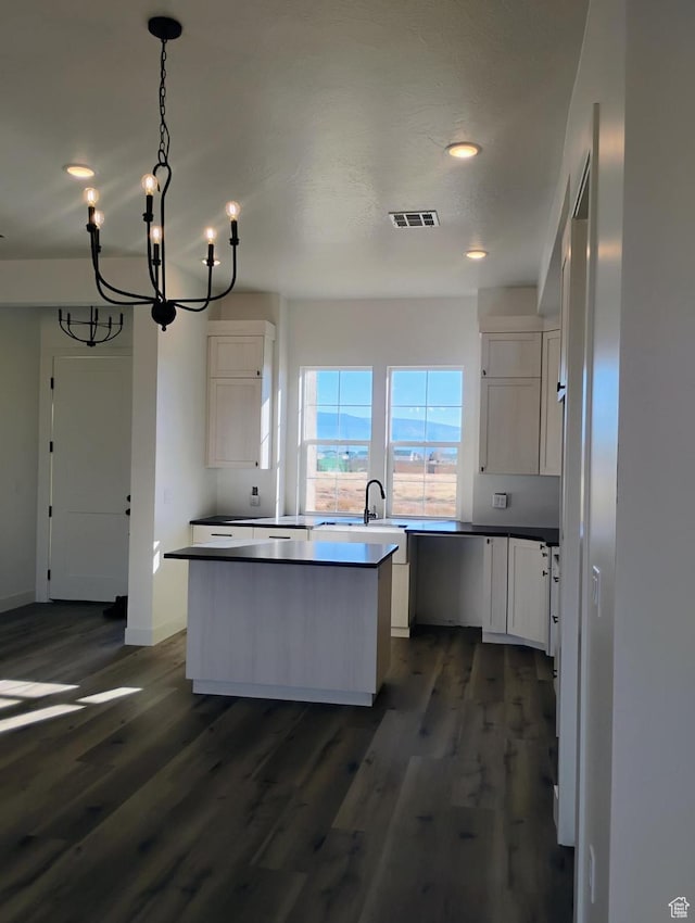 2390 W 5190 N Unit 4, Cedar City, UT 84721 - kitchen with decorative light fixtures, dark wood-type flooring, a center island, and white cabinets