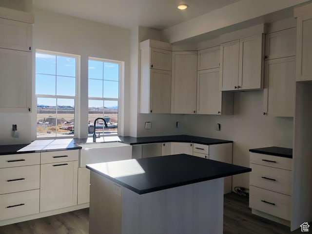 2390 W 5190 N Unit 4, Cedar City, UT 84721 - kitchen with a kitchen island, sink, white cabinets, and dark hardwood / wood-style floors