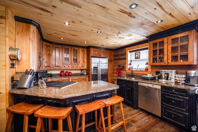 18906 N Canyon Rd, Whiterocks, UT 84085 - kitchen featuring a breakfast bar area, appliances with stainless steel finishes, light stone countertops, dark wood-type flooring, and wooden walls