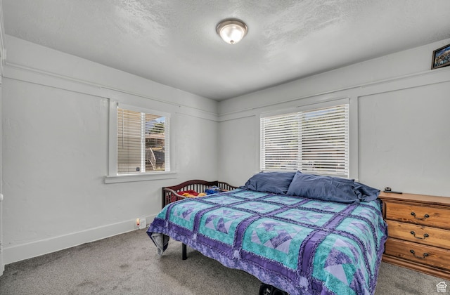 bedroom featuring carpet floors and a textured ceiling