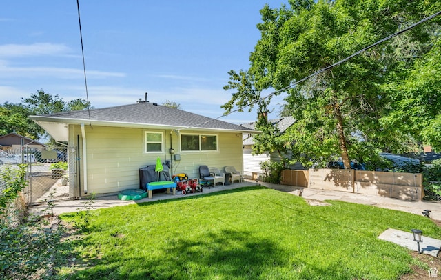rear view of house with a patio area and a lawn
