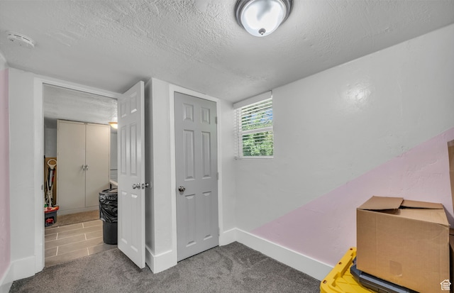 interior space with a closet and a textured ceiling