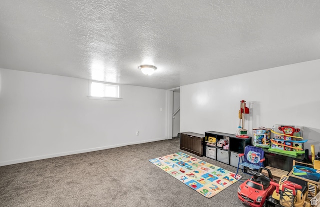 rec room with a textured ceiling and carpet floors