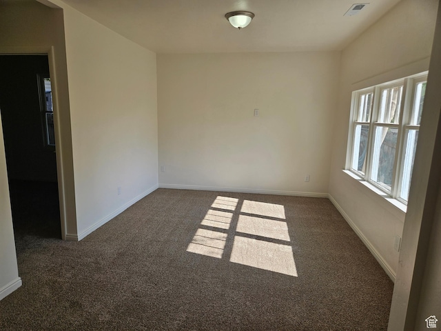 551 E Commonwealth Ave, Salt Lake City, UT 84106 - unfurnished room with dark carpet, baseboards, and visible vents