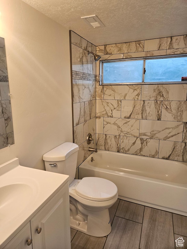 551 E Commonwealth Ave, Salt Lake City, UT 84106 - bathroom with toilet, vanity, a textured ceiling, and  shower combination