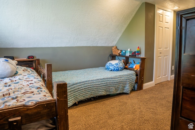 bedroom featuring baseboards, a textured ceiling, carpet, and vaulted ceiling