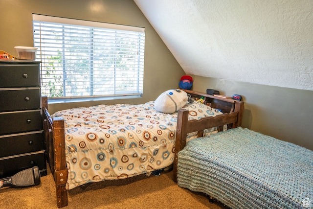 carpeted bedroom with a textured ceiling and lofted ceiling