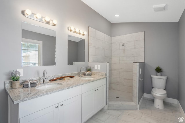 full bath with double vanity, a sink, a walk in shower, and toilet