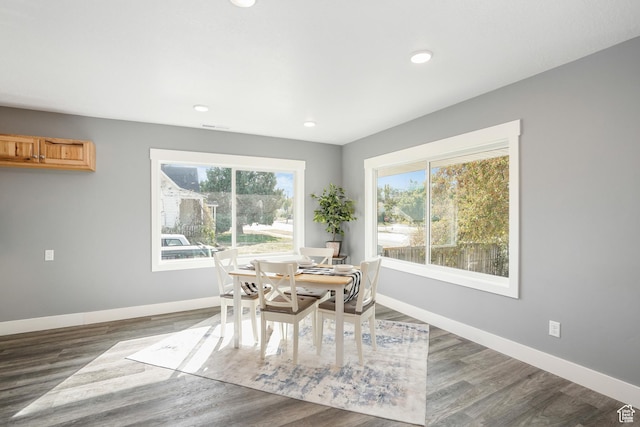 dining space with recessed lighting, wood finished floors, and baseboards