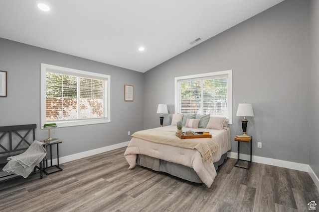 bedroom featuring lofted ceiling, visible vents, recessed lighting, and multiple windows