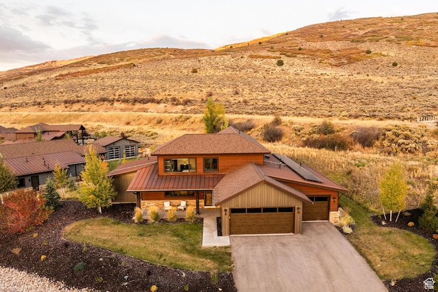 498 Thorn Creek Dr, Kamas, UT 84036 - view of front of house with solar panels, a standing seam roof, a mountain view, and a metal roof