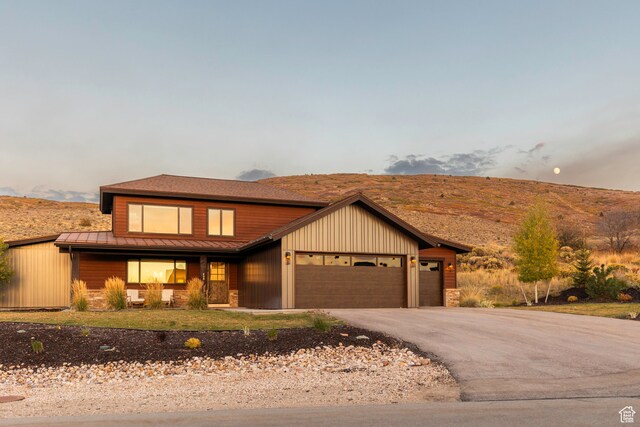 view of front of property with a mountain view and a garage