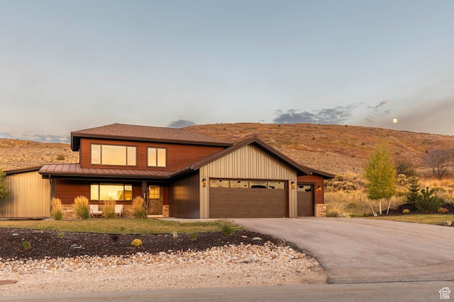 498 Thorn Creek Dr, Kamas, UT 84036 - view of front facade with a standing seam roof, a garage, driveway, a metal roof, and covered porch