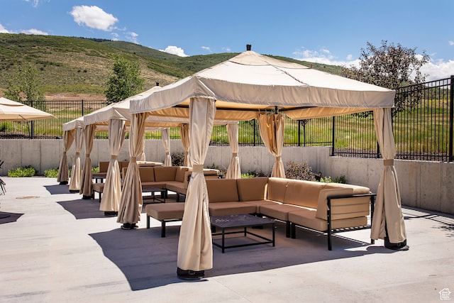 view of patio / terrace featuring a gazebo, outdoor lounge area, and a mountain view