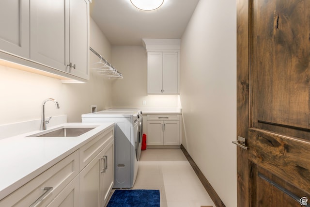 washroom featuring cabinets, independent washer and dryer, sink, and light tile patterned flooring