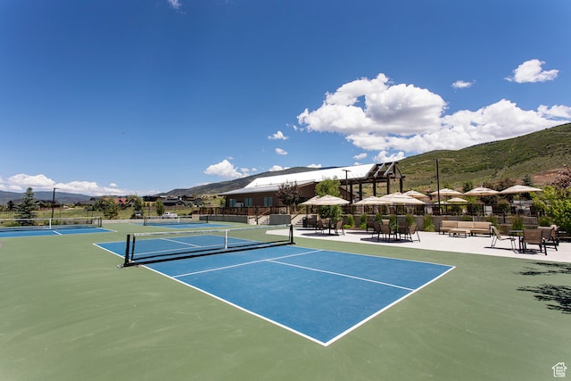 view of tennis court with a mountain view