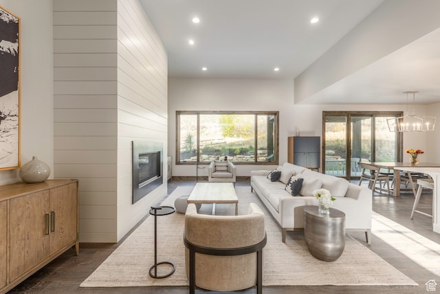 living room with a notable chandelier and dark hardwood / wood-style floors