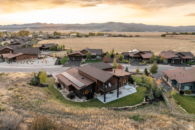 aerial view at dusk featuring a mountain view