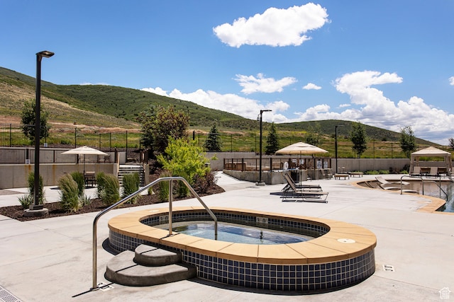 surrounding community featuring a gazebo, a mountain view, a patio, and a jacuzzi