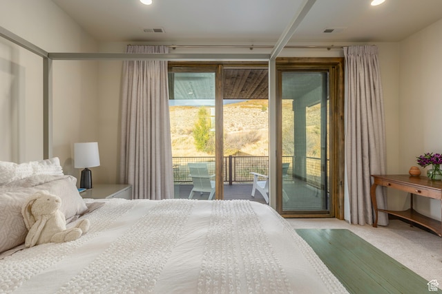 bedroom featuring access to outside, multiple windows, and carpet floors